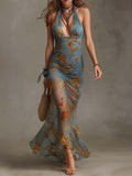 Look de vacaciones con vestido largo resort azul y sandalias planas